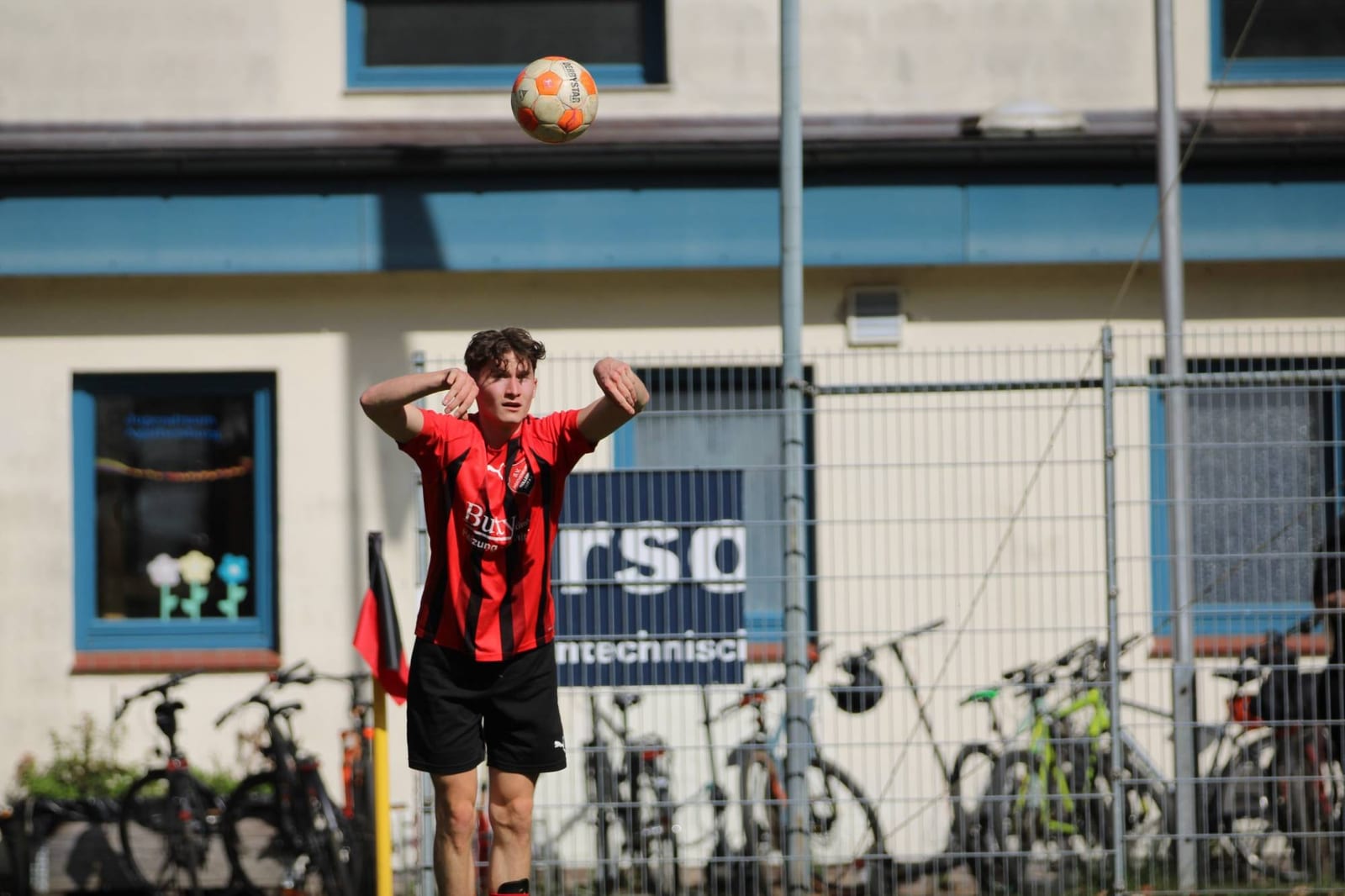 Ein Spieler steht mit beiden Händen am Kopf an der Seitenlinie, über ihm fliegt der Ball